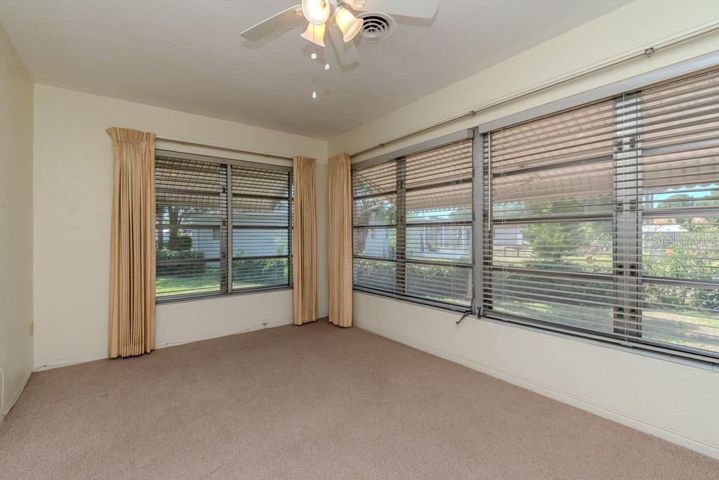 BIG FLORIDA ROOM - WINDOWS HAVE AWNINGS THAT KEEP IT SOMEWHAT SHADED FROM THE DIRECT SUNLIGHT