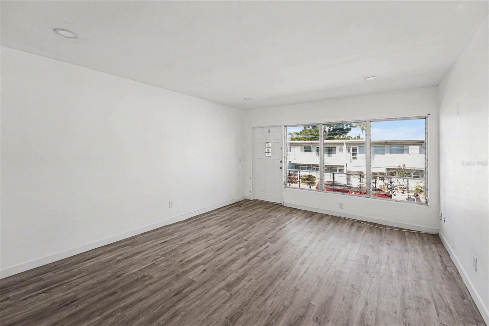 Open floor plan. Living room, dining room, kitchen. The kitchen opens up to a flex room, filled with natural light.