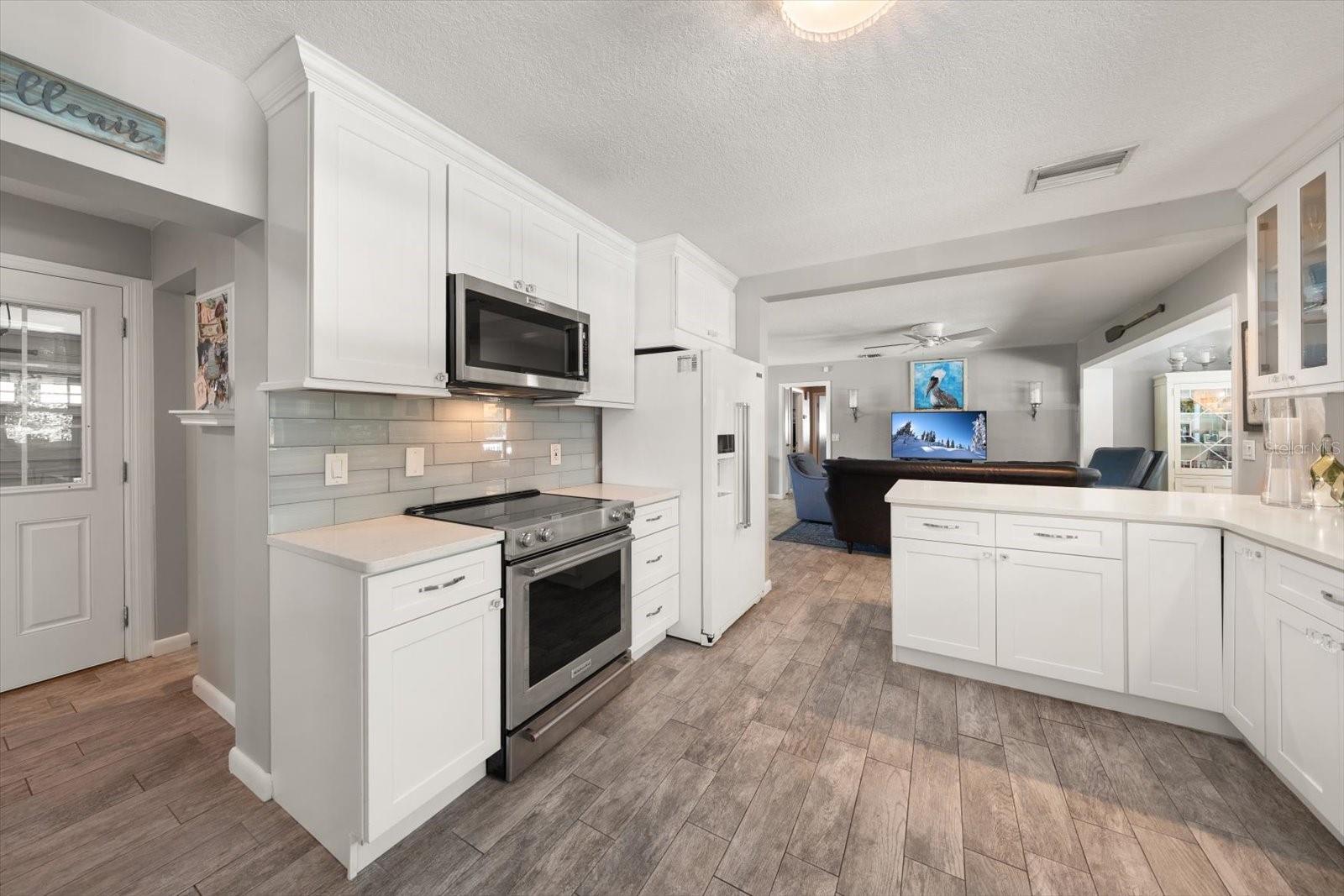 Fridge, Oven, and Microwave View with a visual of the Living Room