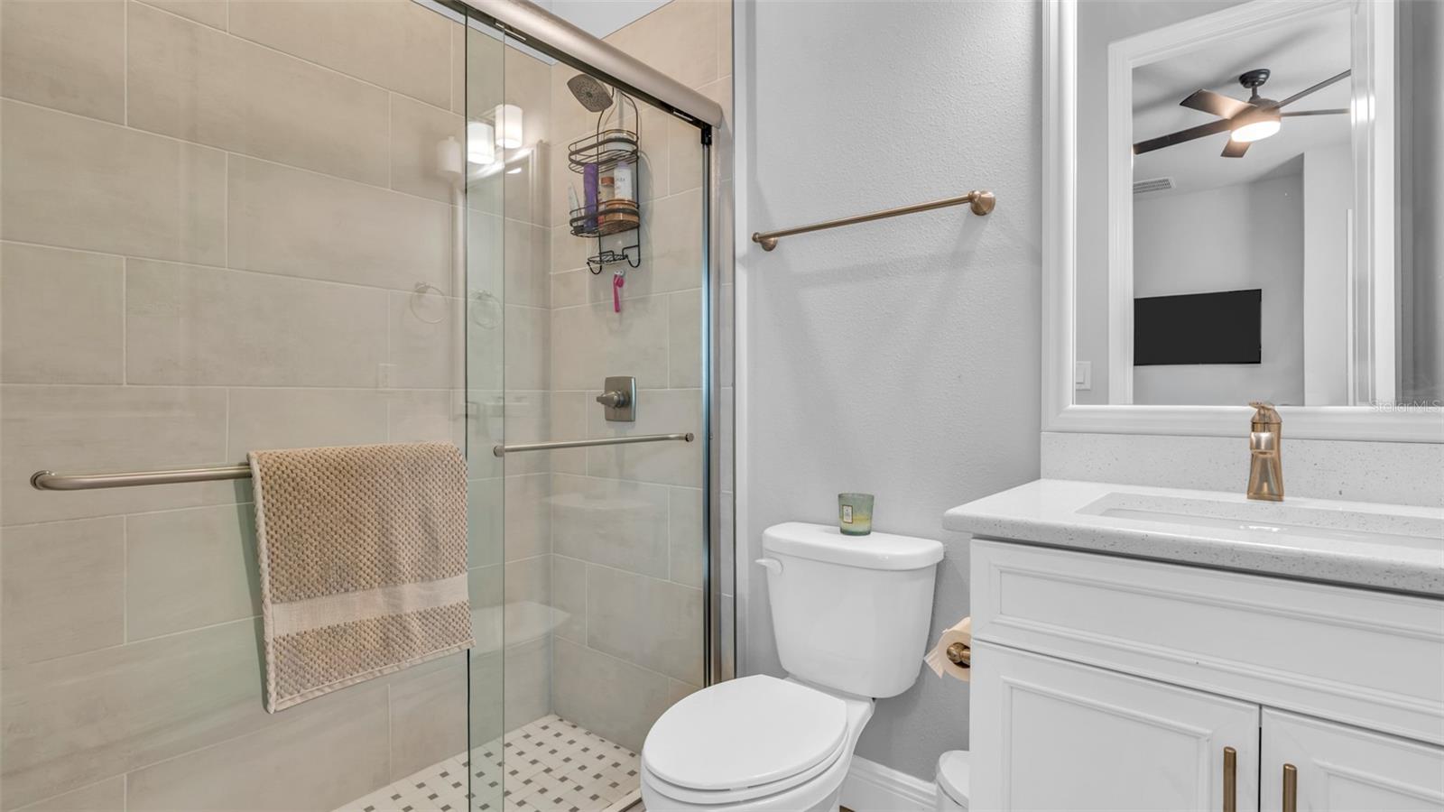 Bedroom off of dining room has bathroom with shower.