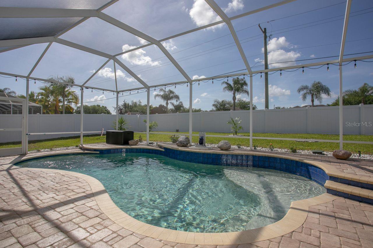 Pool and Pool Cage with Pavered Deck
