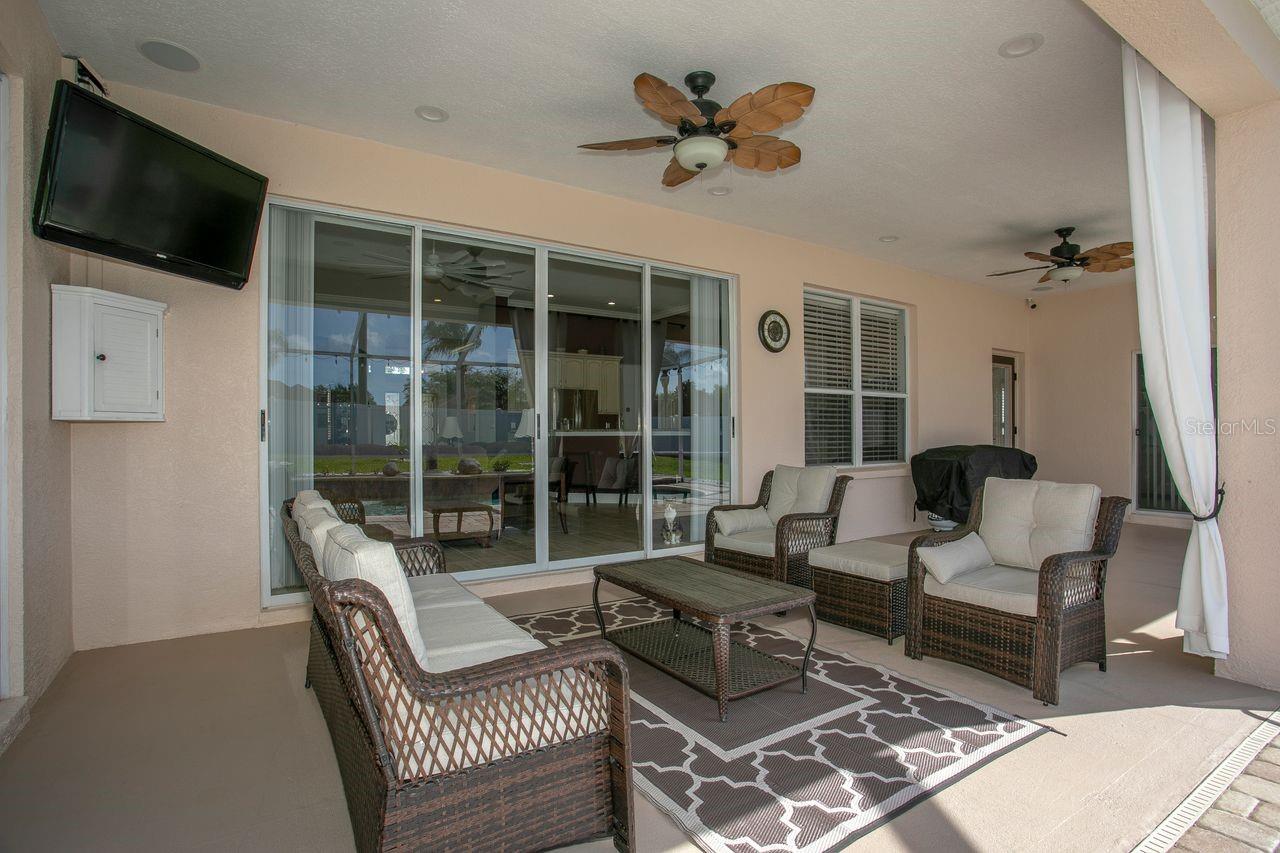 Covered Rear Porch with Dual Ceiling Fans, Pavers, T.V.