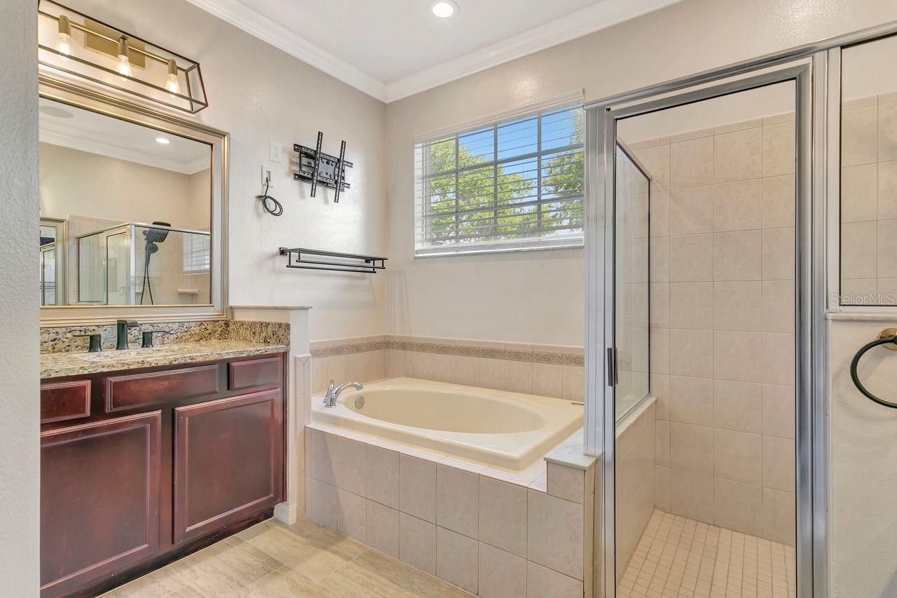 En-Suite Primary Bathroom with Garden Soaking Tub, Shower Stall, and Split Dual Vanities