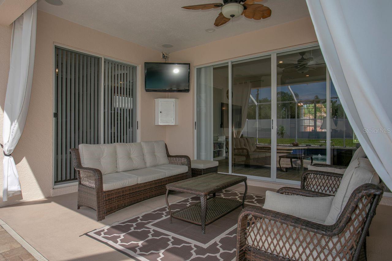 Covered Rear Porch with Dual Ceiling Fans, Pavers, T.V.