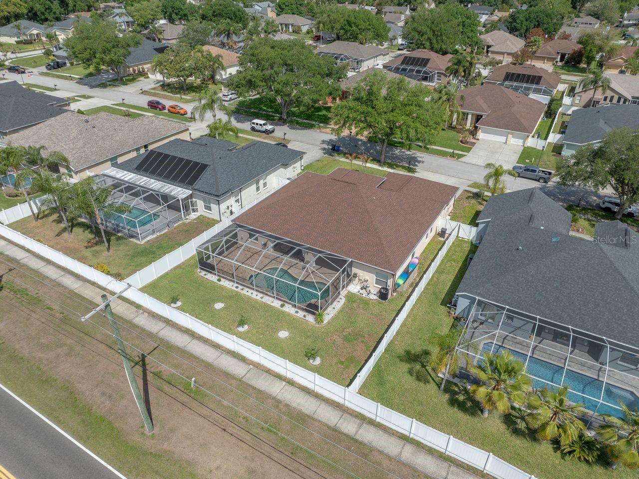 Aerial View of Home with Pool, Pool Cage, and Fully Fenced on a .25 Quarter Acre Lot