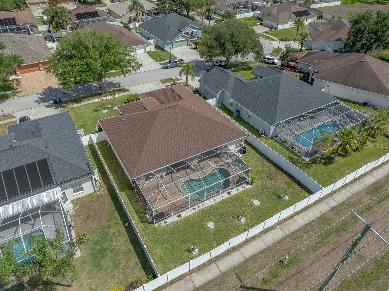 Aerial View of Home with Pool, Pool Cage, and Fully Fenced on a .25 Quarter Acre Lot