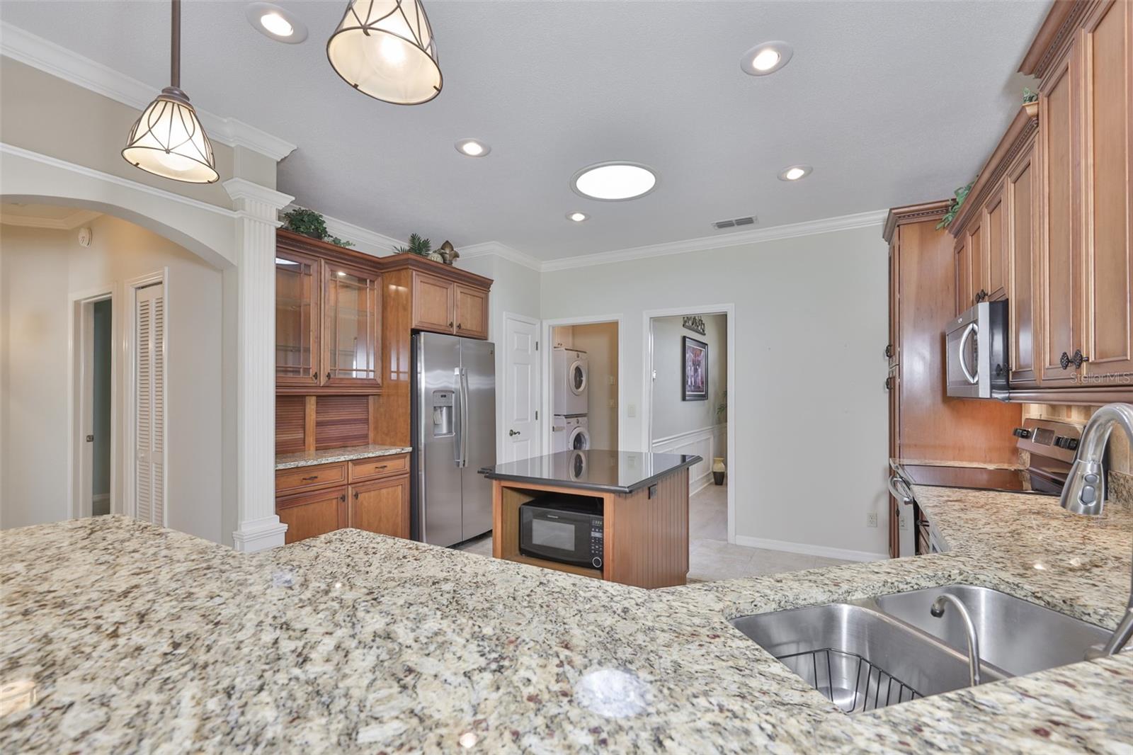 Solid wood cabinets with lights both in and under the cabinets and glass doors for optimum elegance.  everything has been though of in this kithen.