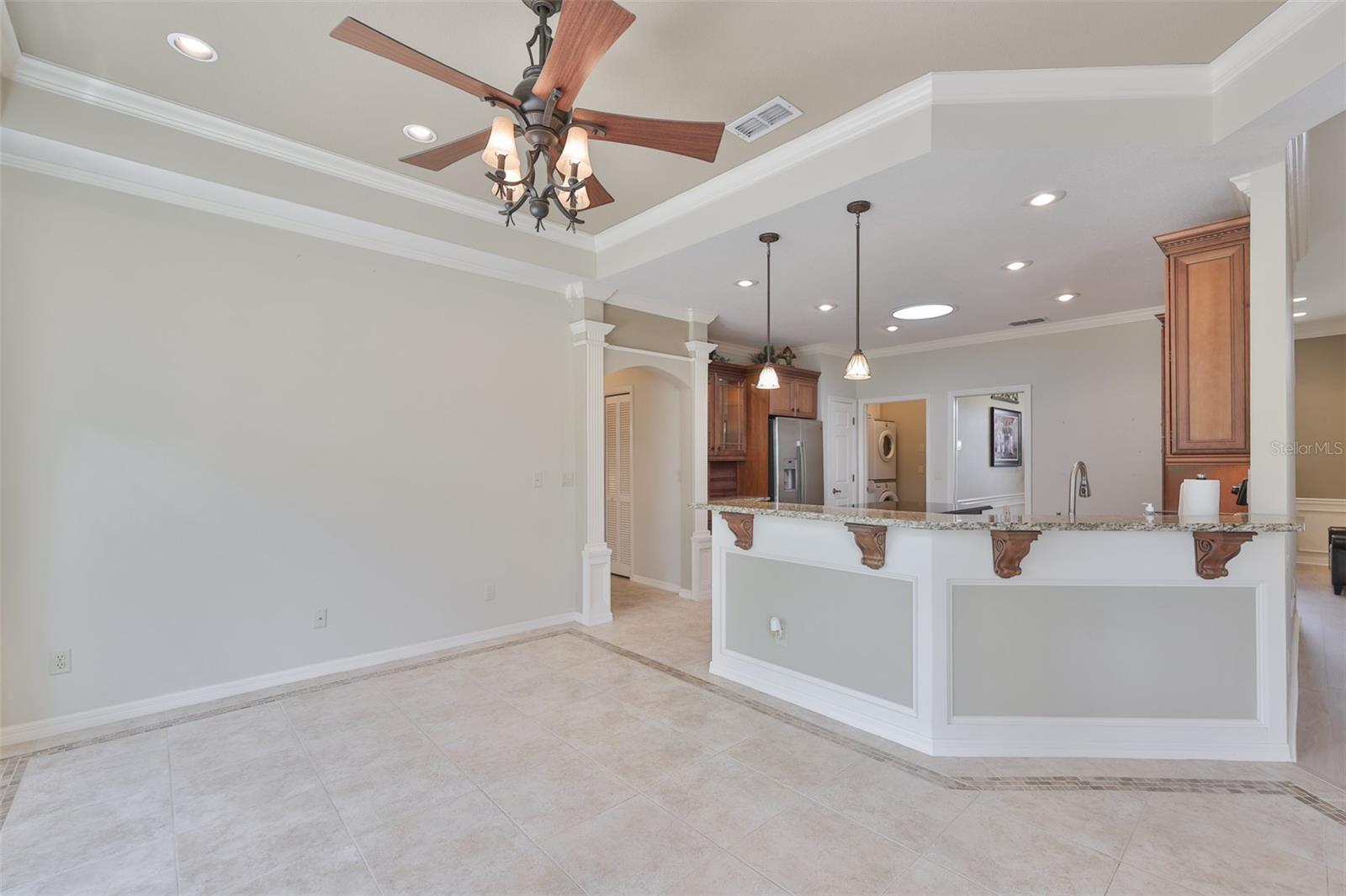 There is even a lovely breakfast bar should you wish to have more space for guests. Again, notice all of the light coming through the overly large windows.