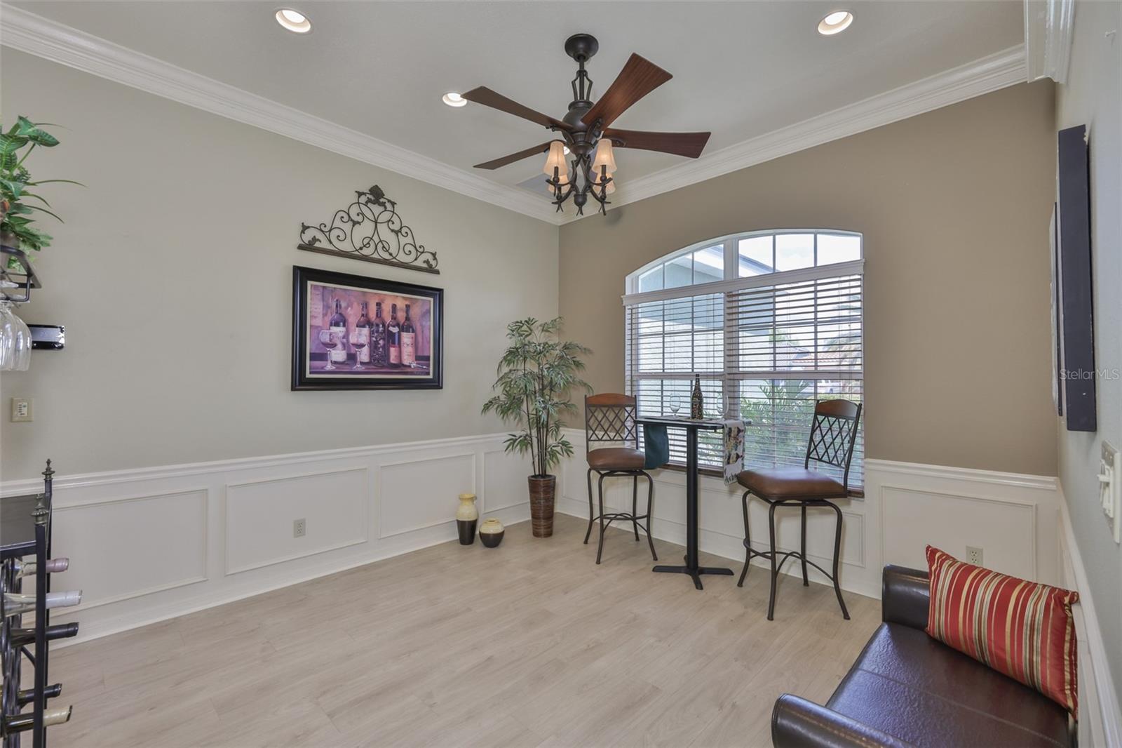 The dining room is just off of the both the kitchen and the great room.  Notice the accent features on the walls, crown molding and custom light fixture.
