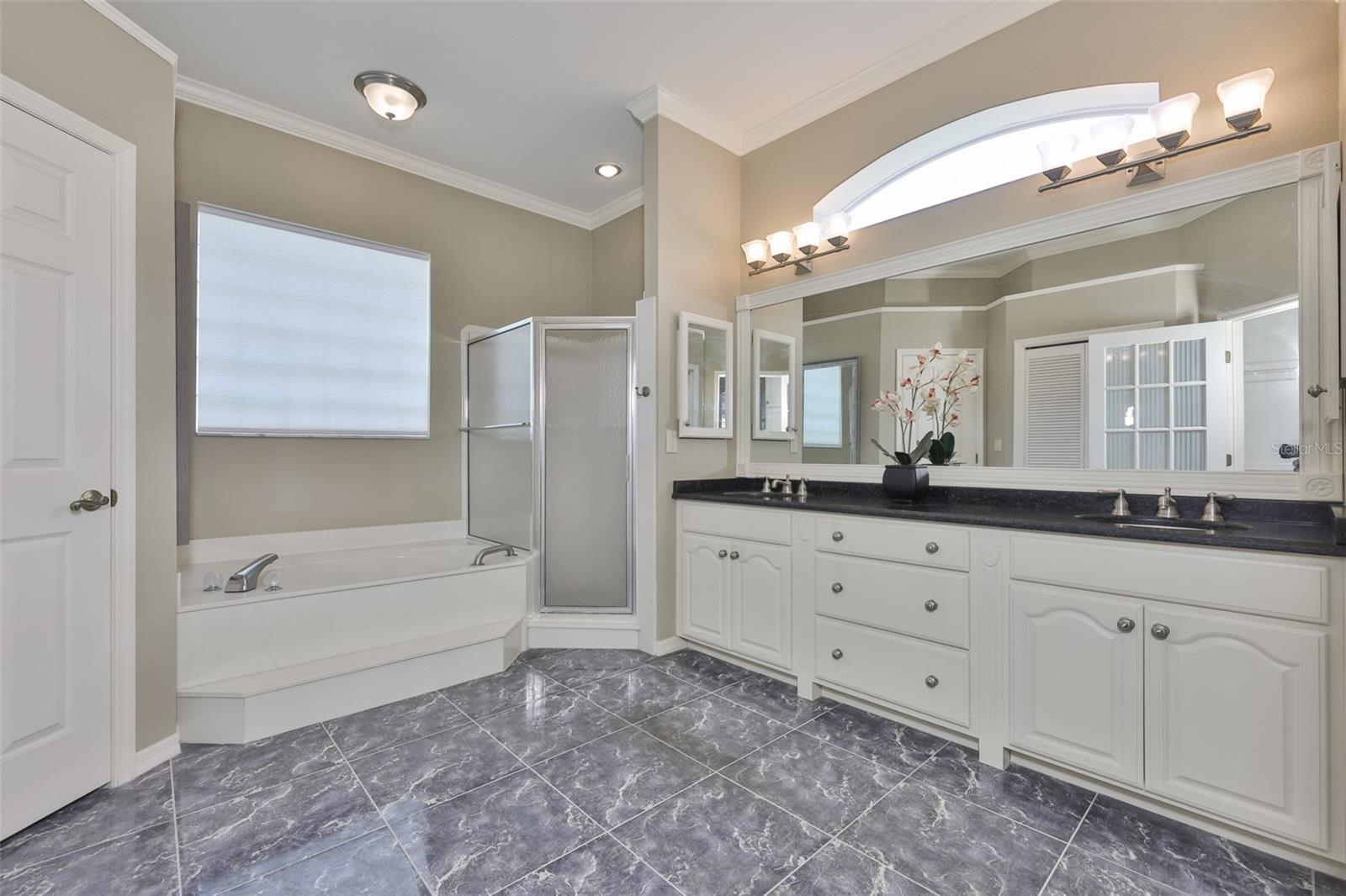 A large garden tub, with separate shower stall and private water closet are all lovely features.