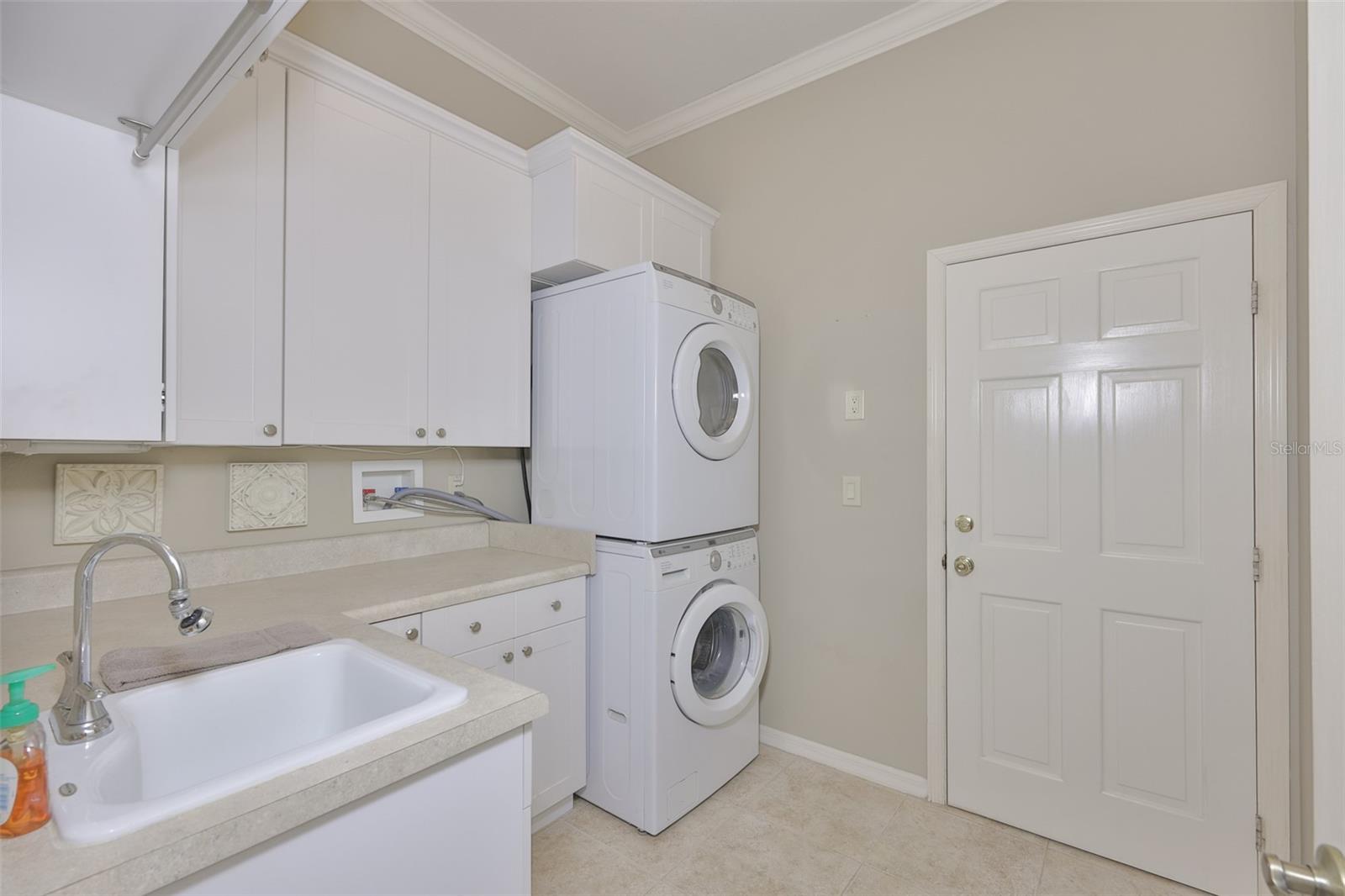 The laundry room boasts of newer appliances, lots of storage space and a utility sink.