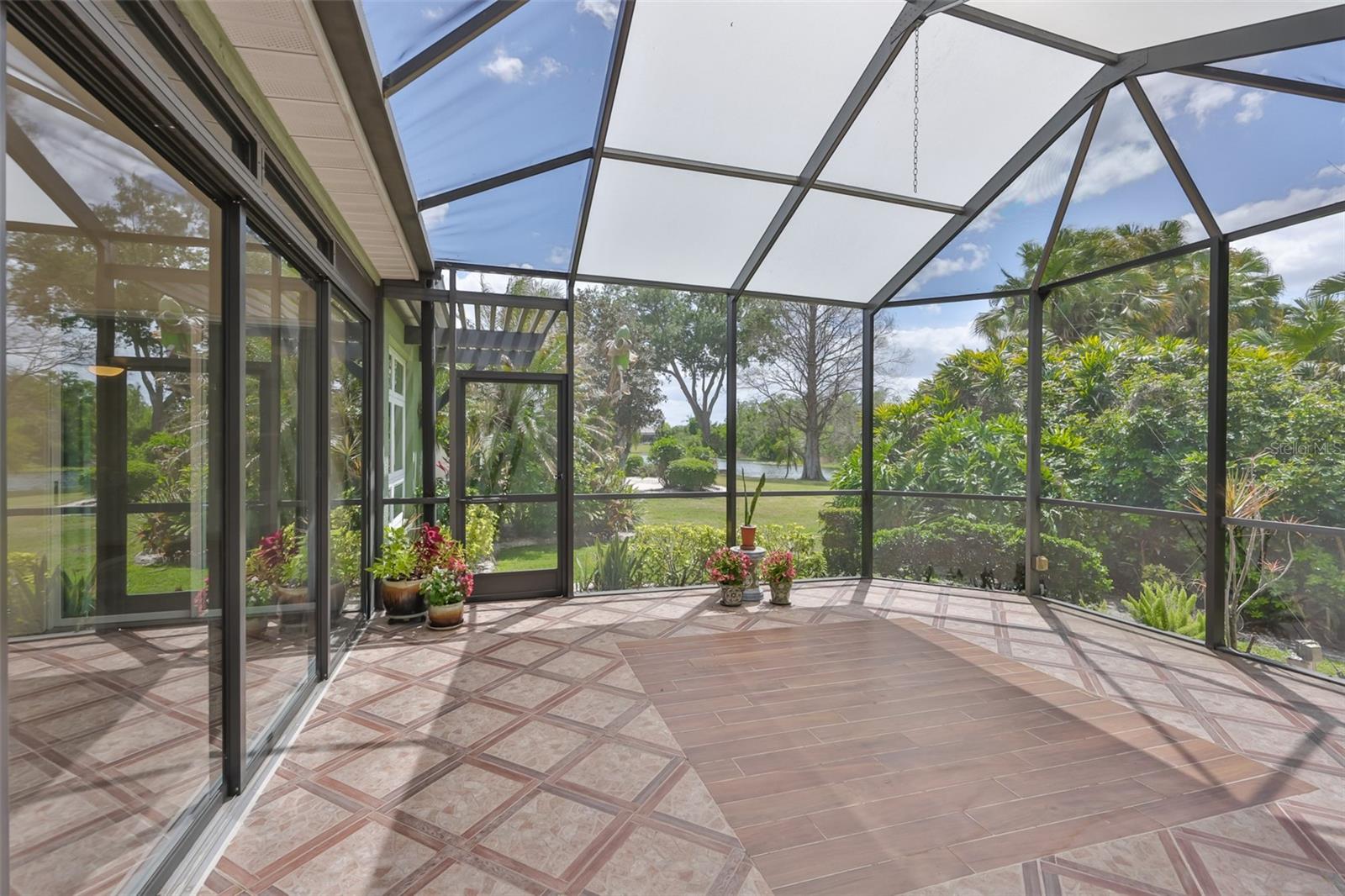 As you step out of the Florida room, you walk into a fully screened lanai, with both a conservation and water view.  Sun Panels in the screen provide additional shading.