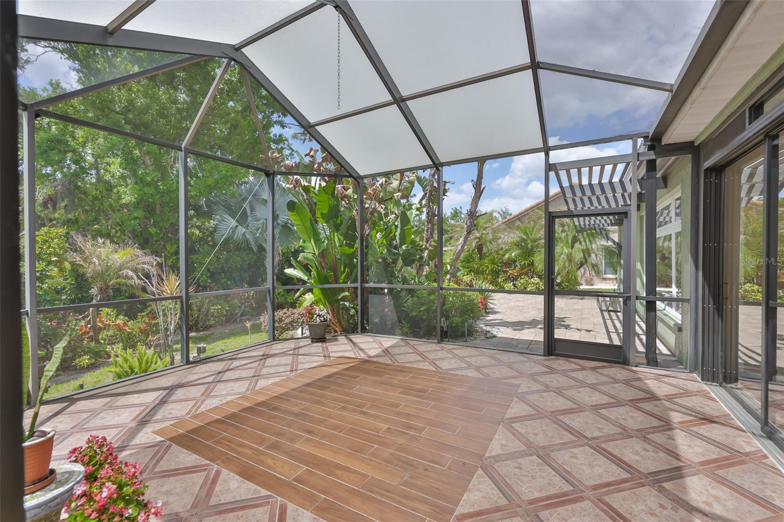 From the screened lanai, you can venture out on to the open air, custom pavered patio.