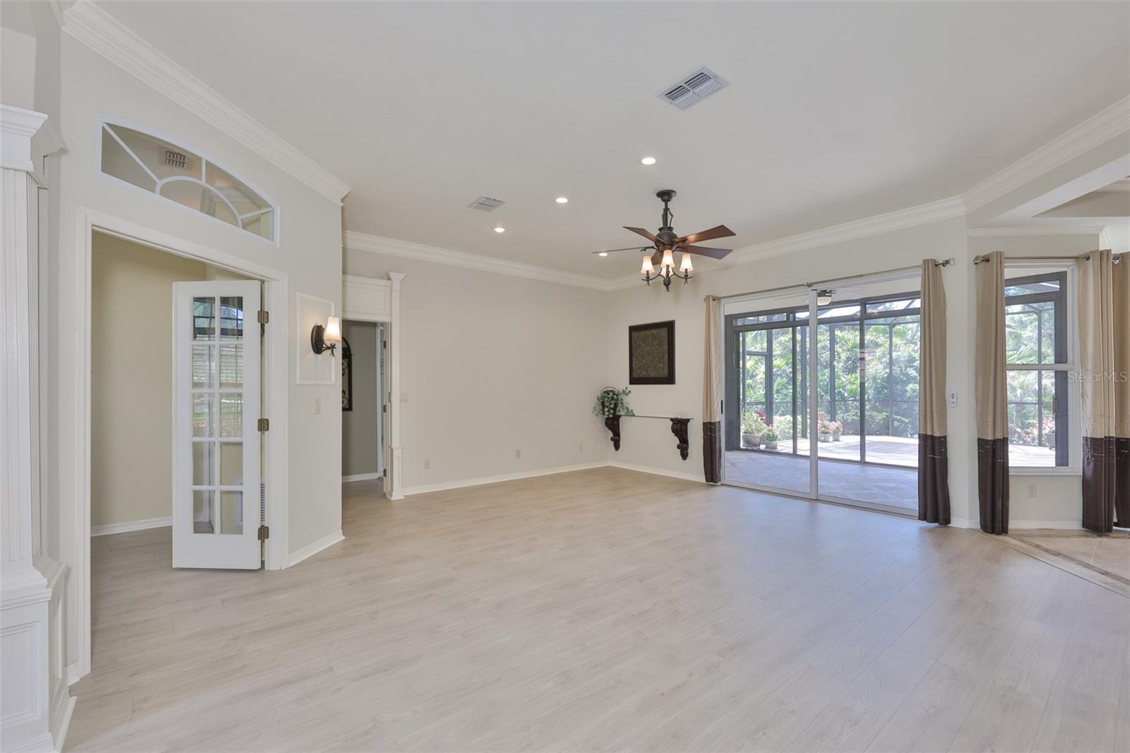 As you enter the home, you are immediately drawn to the all the open space and greenery on the outside of the home. Notice the beautiful, NEW laminate flooring, custom lights and crown molding.
