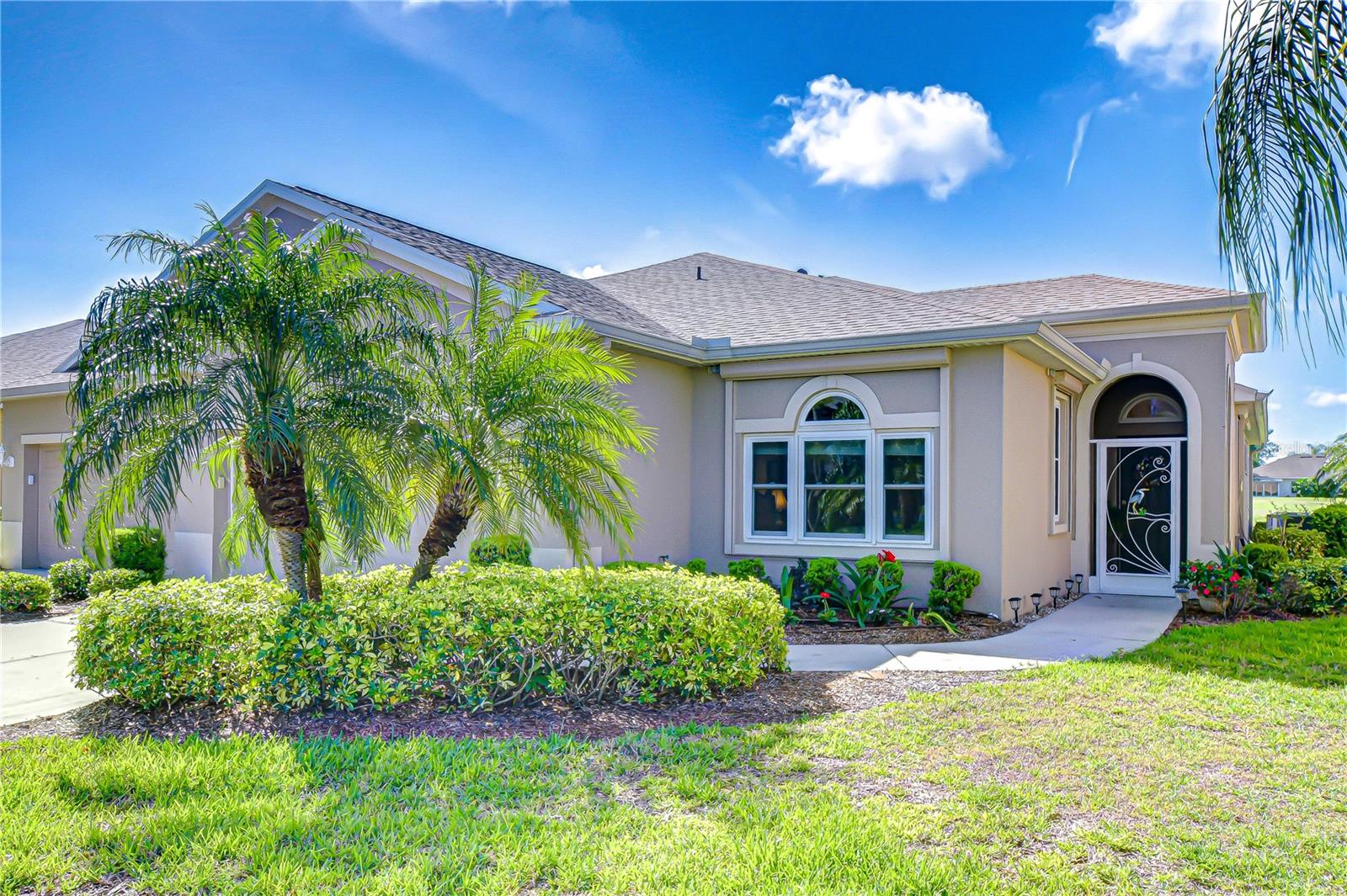 Well-maintained curb appeal with lush landscaping.