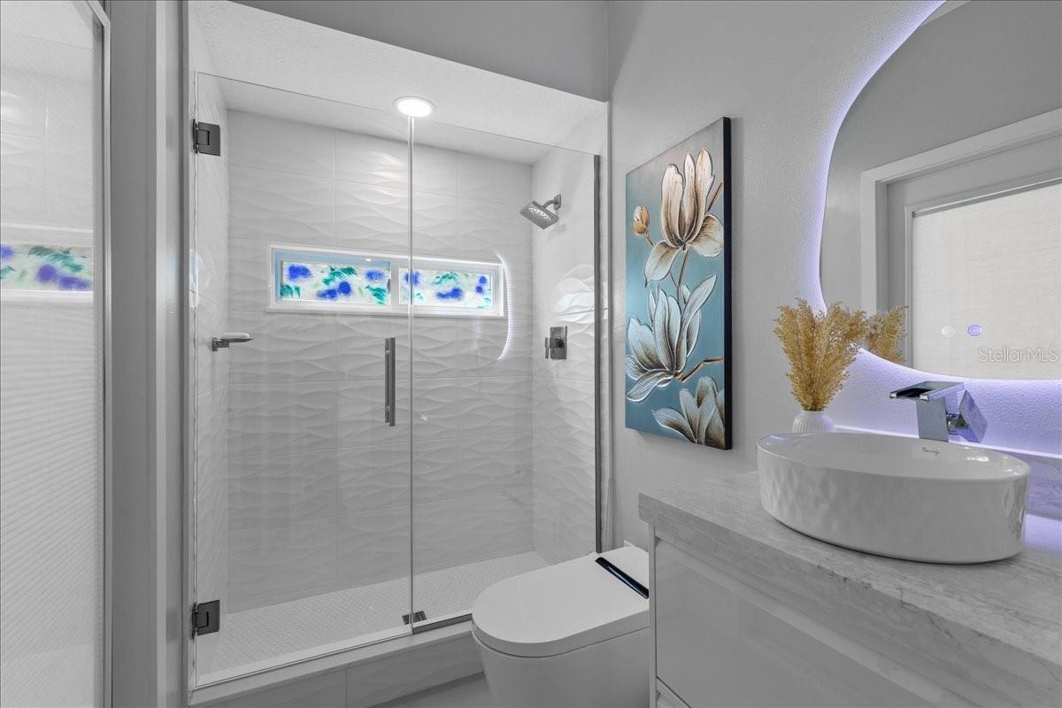 main level full bath with outside patio access