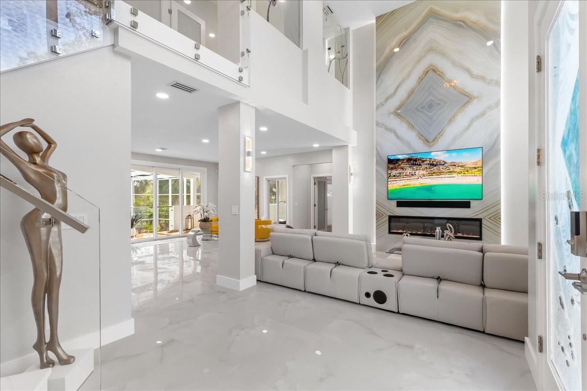 Stunning entry features 20 foot LED accent wall with gas fireplace