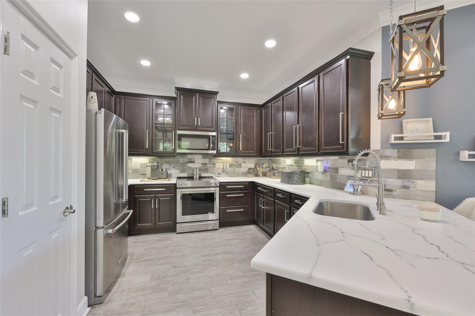 Large closet pantry and open to the rest of the floor plan, you are never "out of the action".