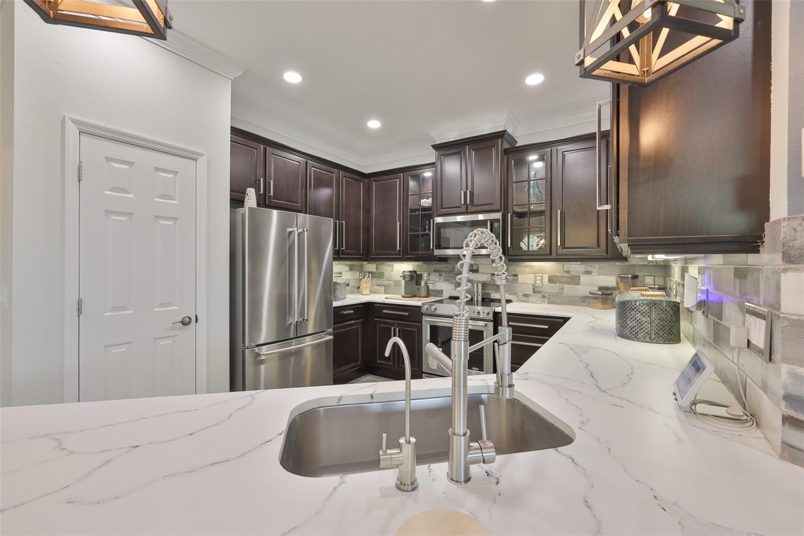 Contemporary fixtures and a tankless reverse osmosis, for continuous water.