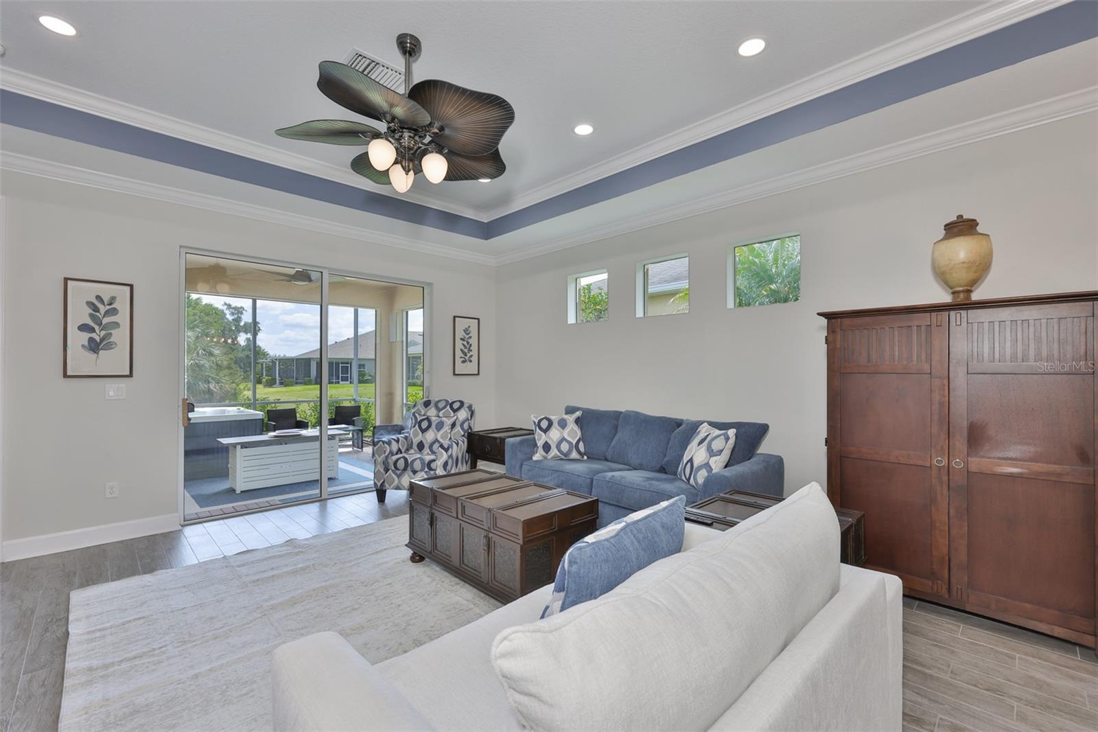 Overly large sliding glass doors and side windows allow natural sunshine to filter throughout the house making it bright.