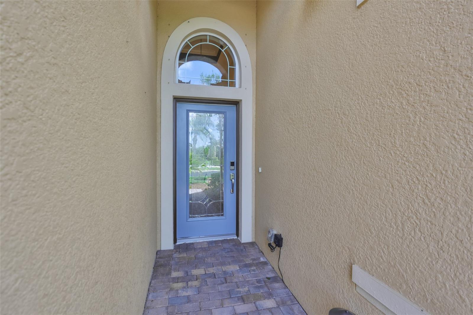 Front entrance provides protection from the elements and the glass door and transom offer lots of natural light into the home.