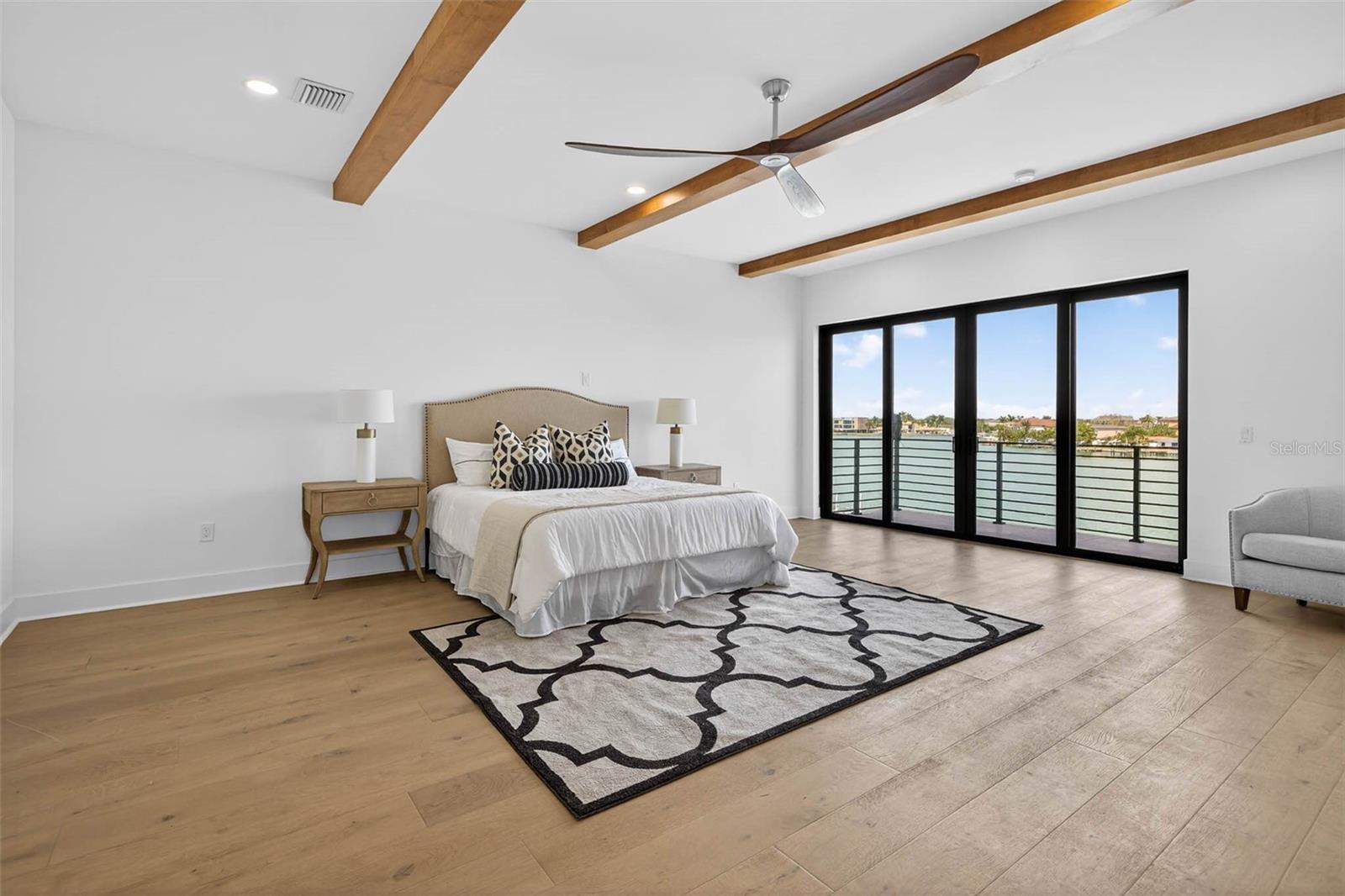 Oversized primary bedroom with water views.