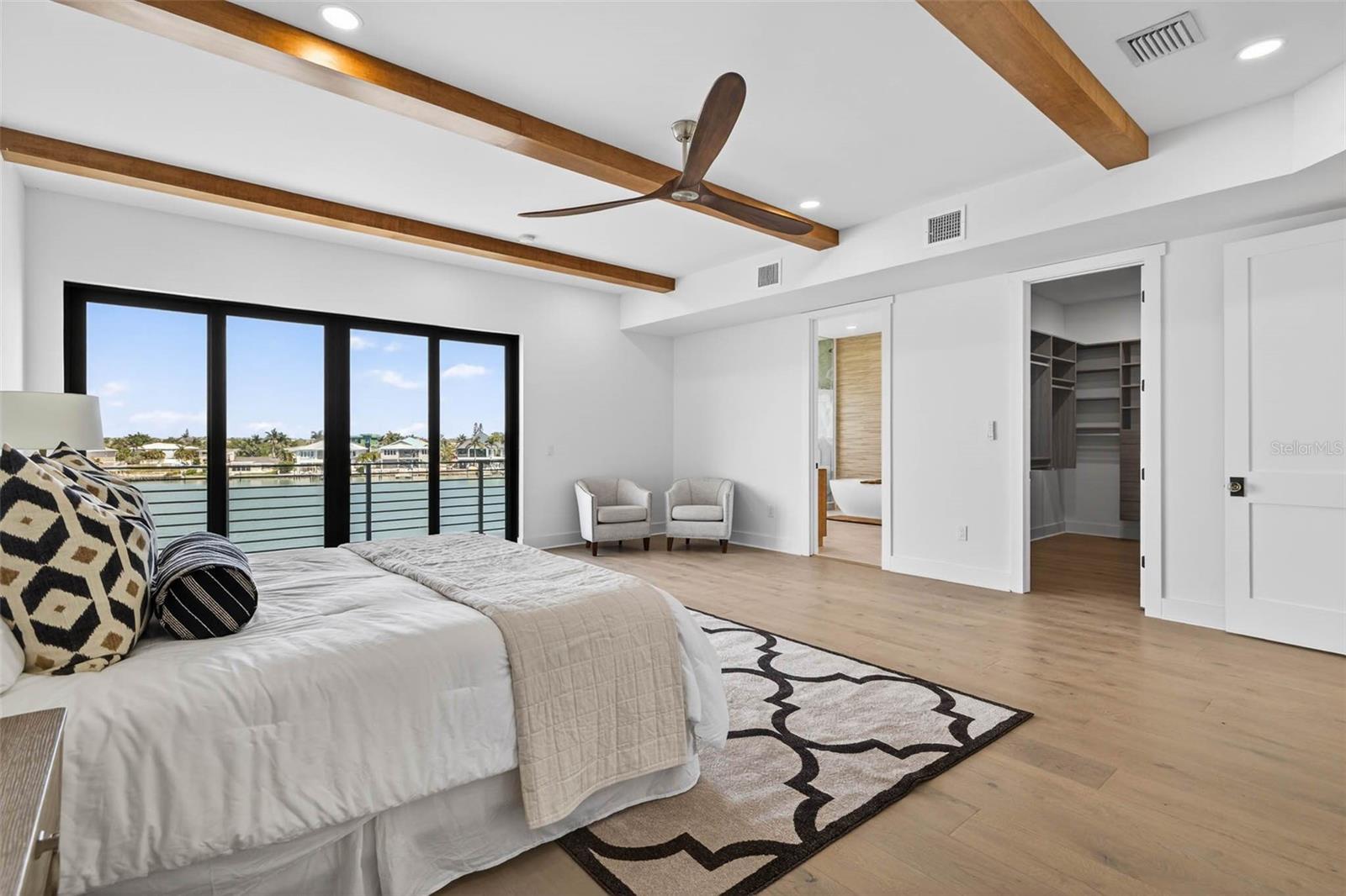 Primary bedroom with dual walk-in closets.