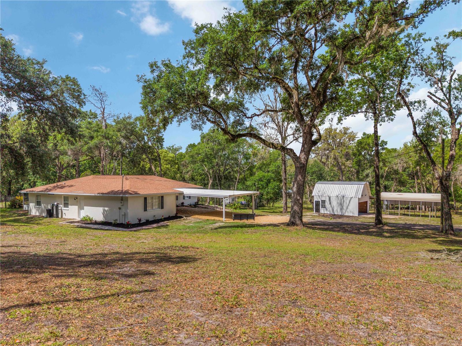 Front yard with workshop and RV- Carport