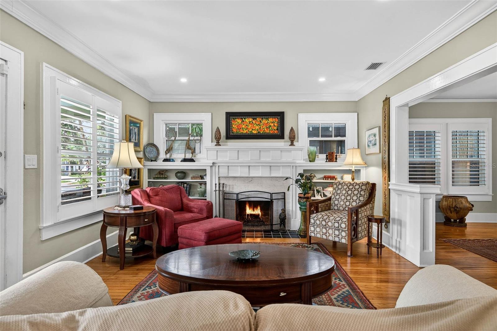 Living Room Anchored with a Charming Wood Burning Fireplace
