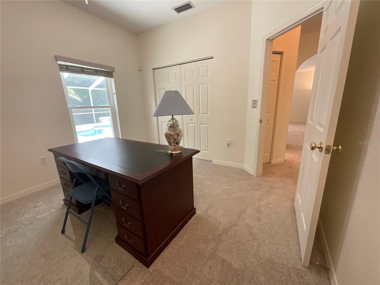 Office/additional bedroom w relaxing view of pool