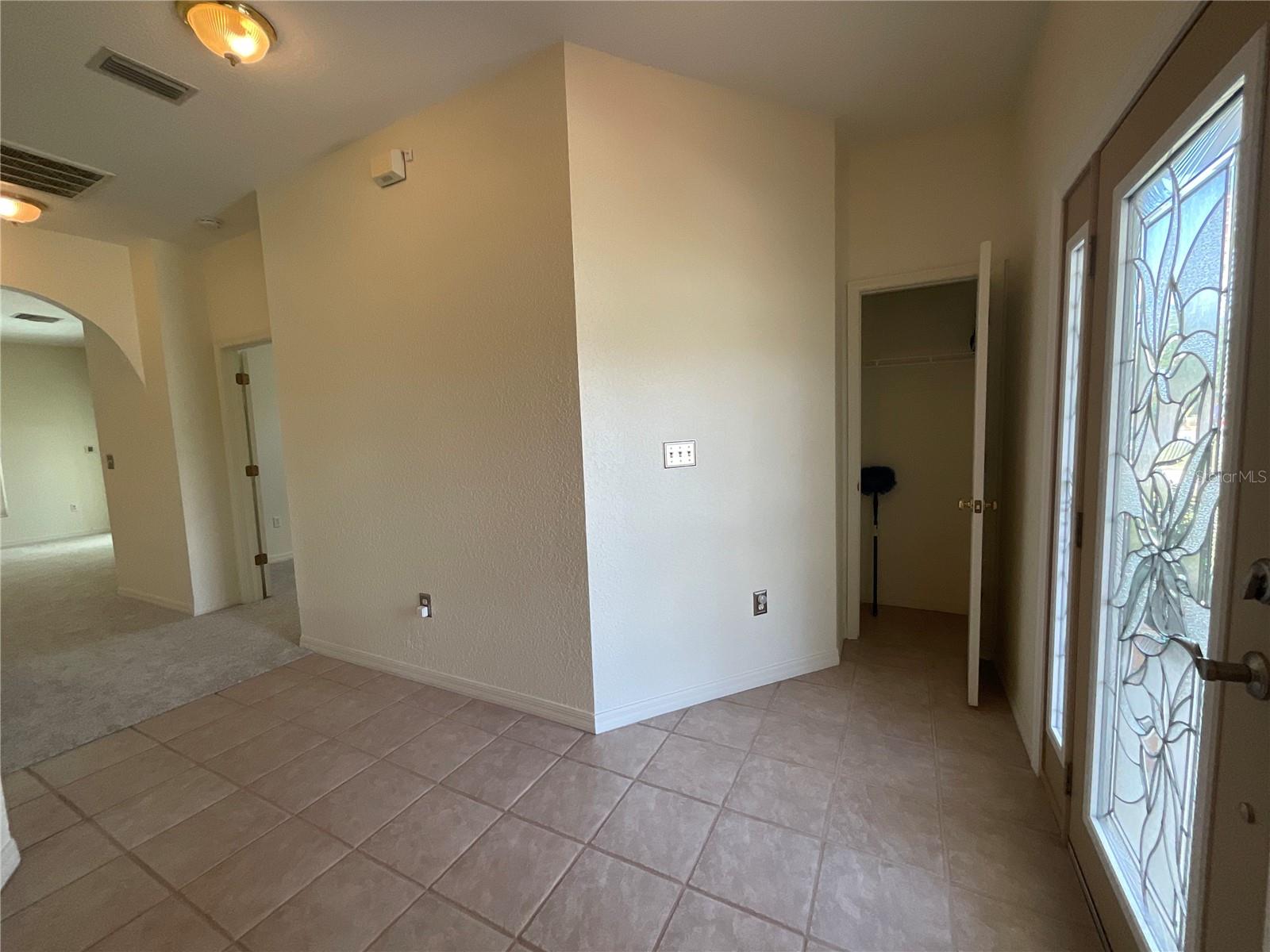 Etched glass in side window and front door, nicely illuminates coat closet area