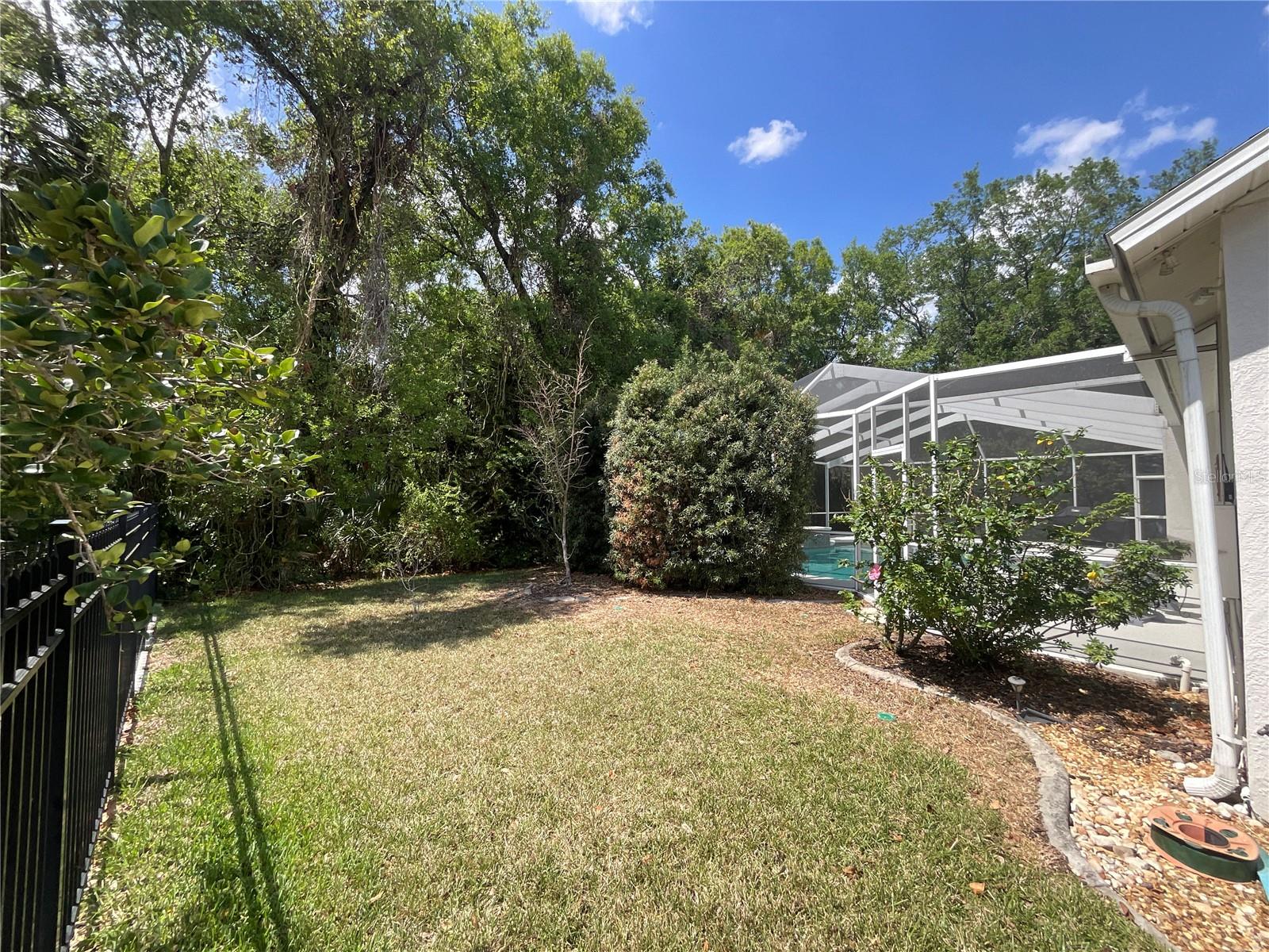 Notice gutters, privacy around pool deck and backyard conservation view