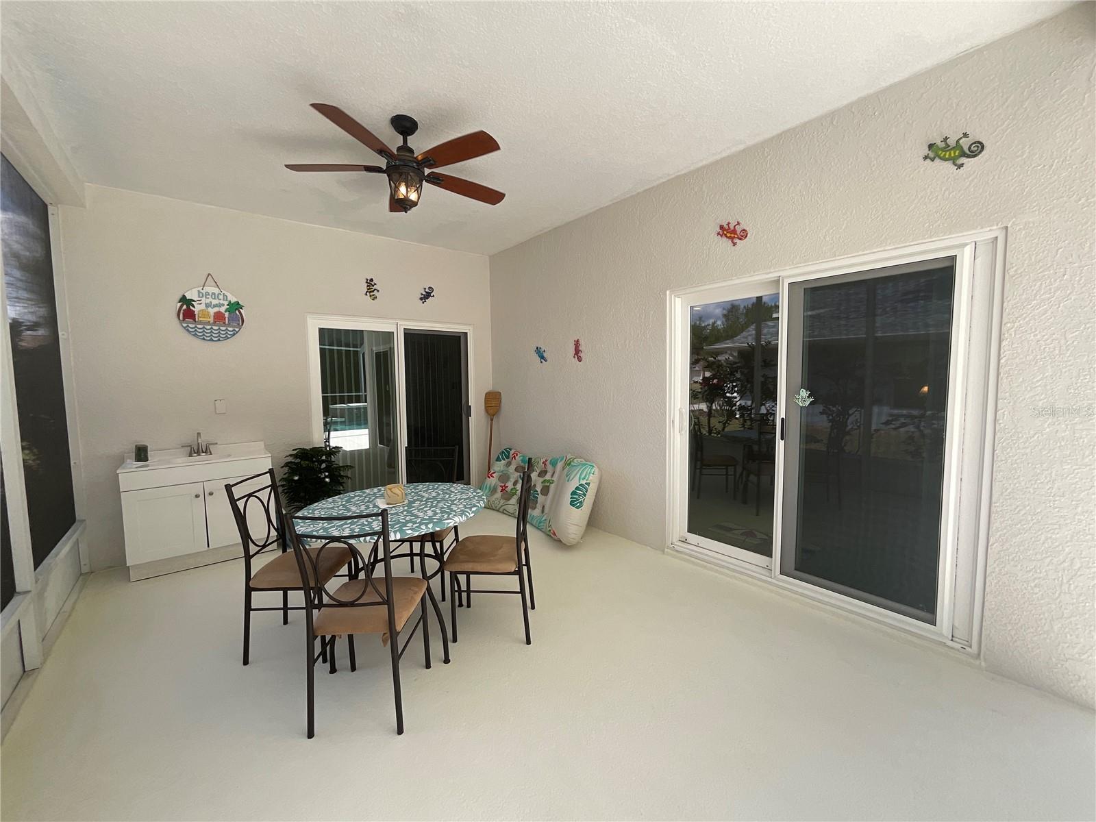 Covered eating area with quick access to outdoor vanity and sink with easy access to owner’s suite or the living room