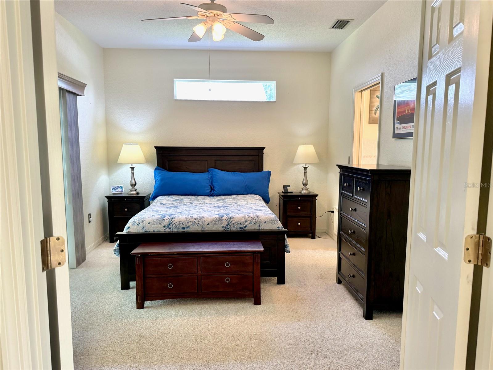 Owner's suite with doors leading to private patio area