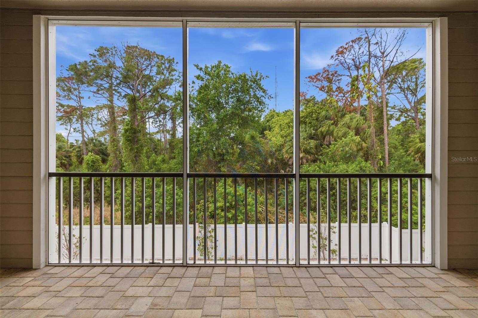 Private balcony overlooking wooded area.