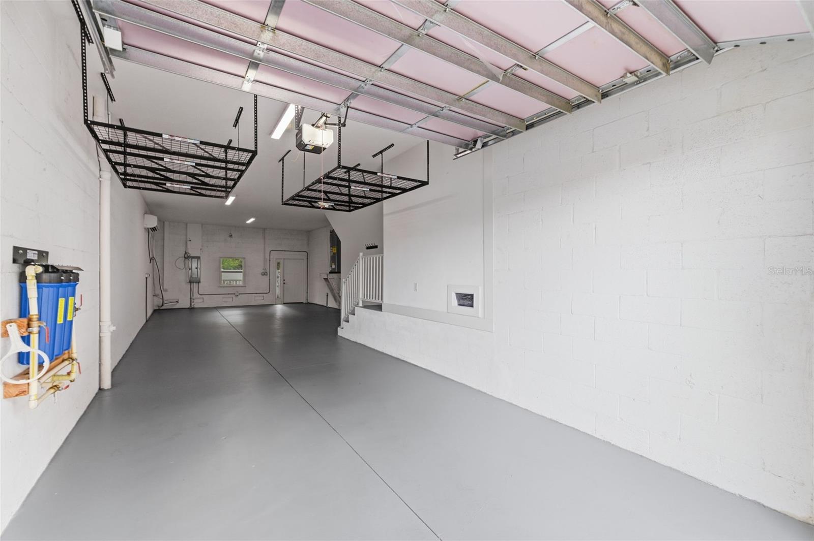 Massive garage with storage and mini split.