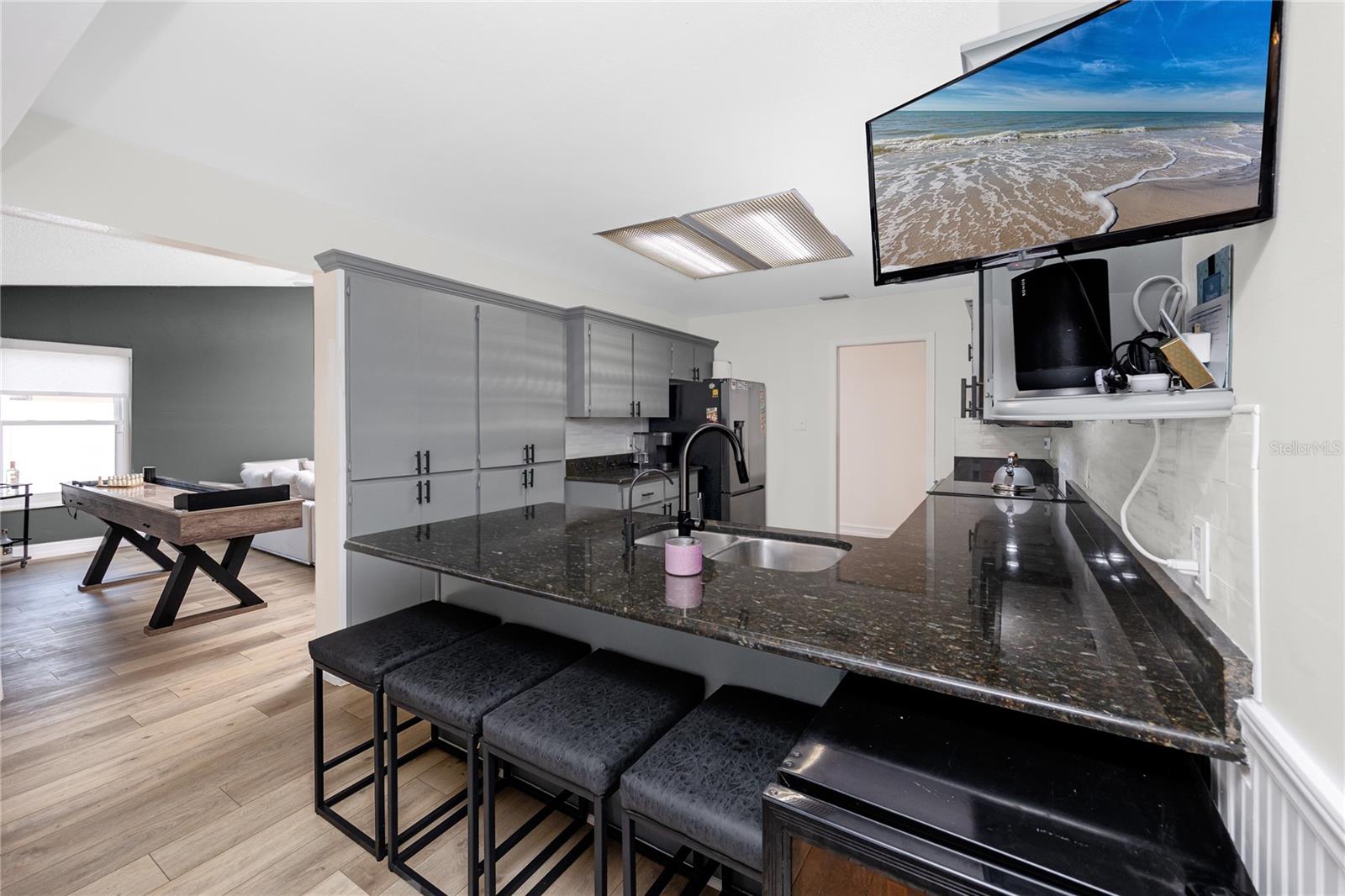 Nice kitchen with eat-in space and access to the 2nd laundry room with vaulted ceilings.