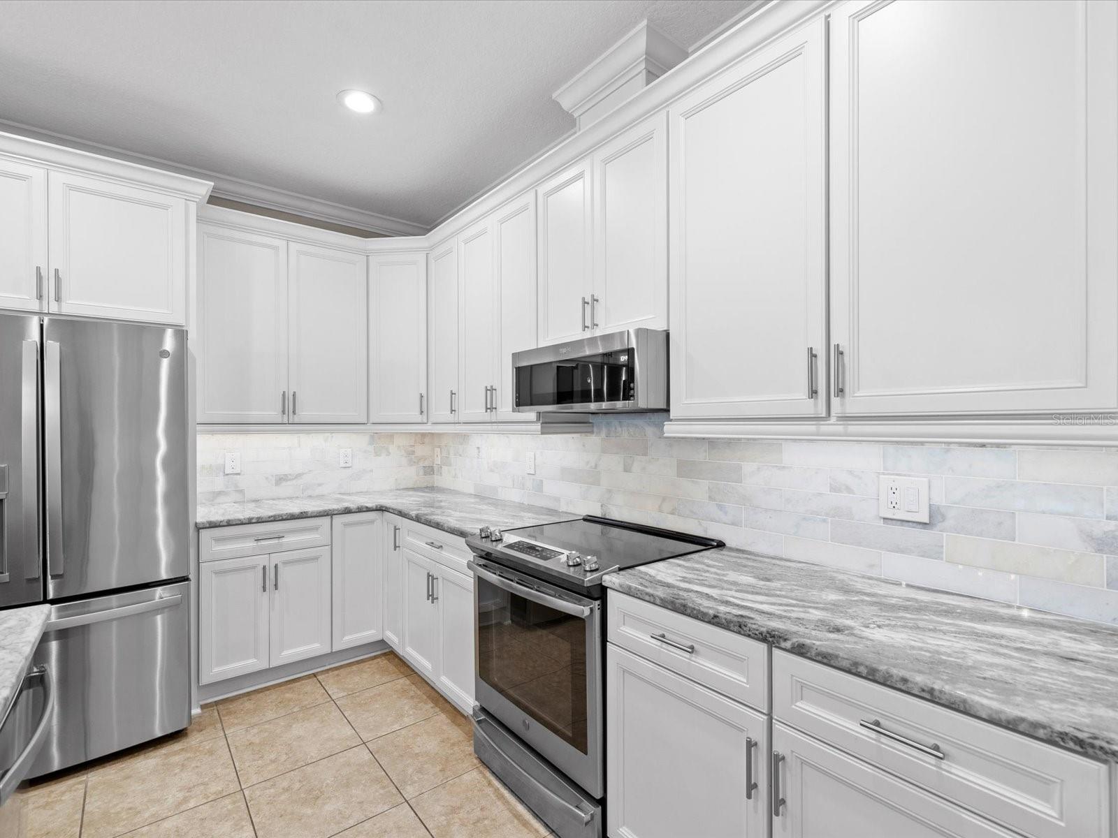Remodeled Kitchen, Granite Countertops, Huge Kitchen Island, Stainless Steel Appliances, Tile Throughout, Crown Molding, Plantation Shutters, Hybrid HVAC, Smart Home