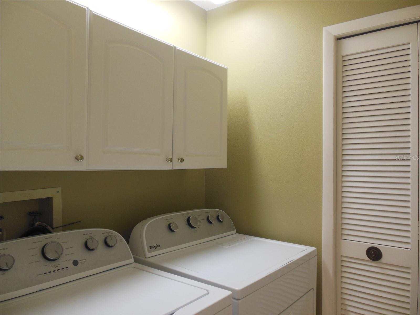 Laundry Room with wall cabinets . ..