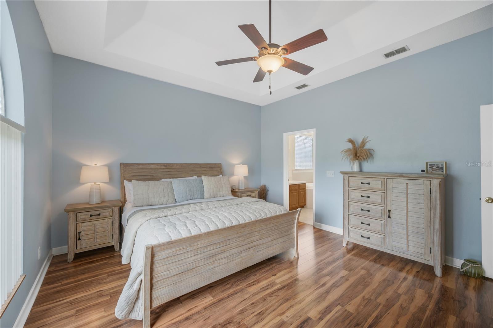 Primary bedroom with en-suite bath is on a first floor wing separate from the secondary bedrooms for privacy.