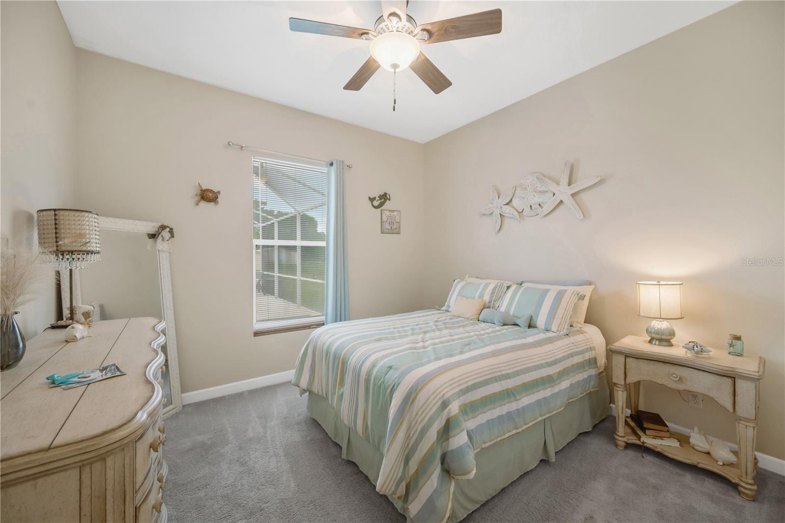2nd bedroom has a large built-in closet, carpet & ceiling fan.