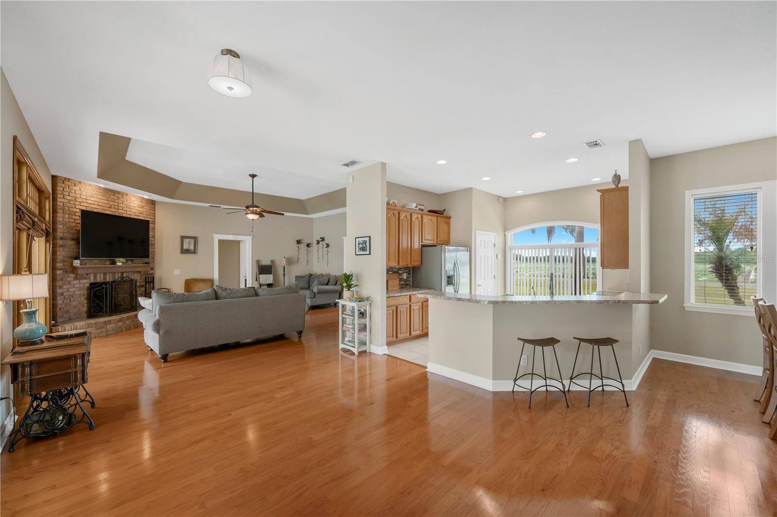 The open-concept kitchen is designed for both comfort and connection, featuring a spacious breakfast bar, stainless steel appliances, large walk-in storage pantry and a seamless flow into the dining and living areas -perfect for everything from casual mornings to holiday gatherings.