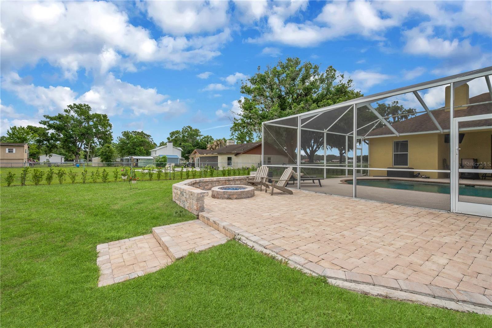 A beautiful newly added paver patio with a firepit is perfect for evenings under the stars.