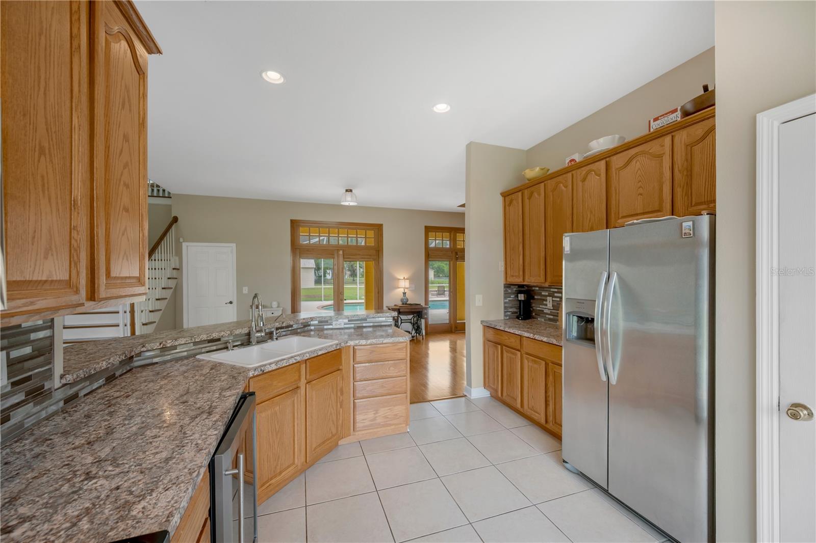 Kitchen highlights include tall cabinetry, a wine refrigerator, additional breakfast bar seating, a deep walk-in pantry and a double-basin sink.  Reverse Osmosis filter under sink.