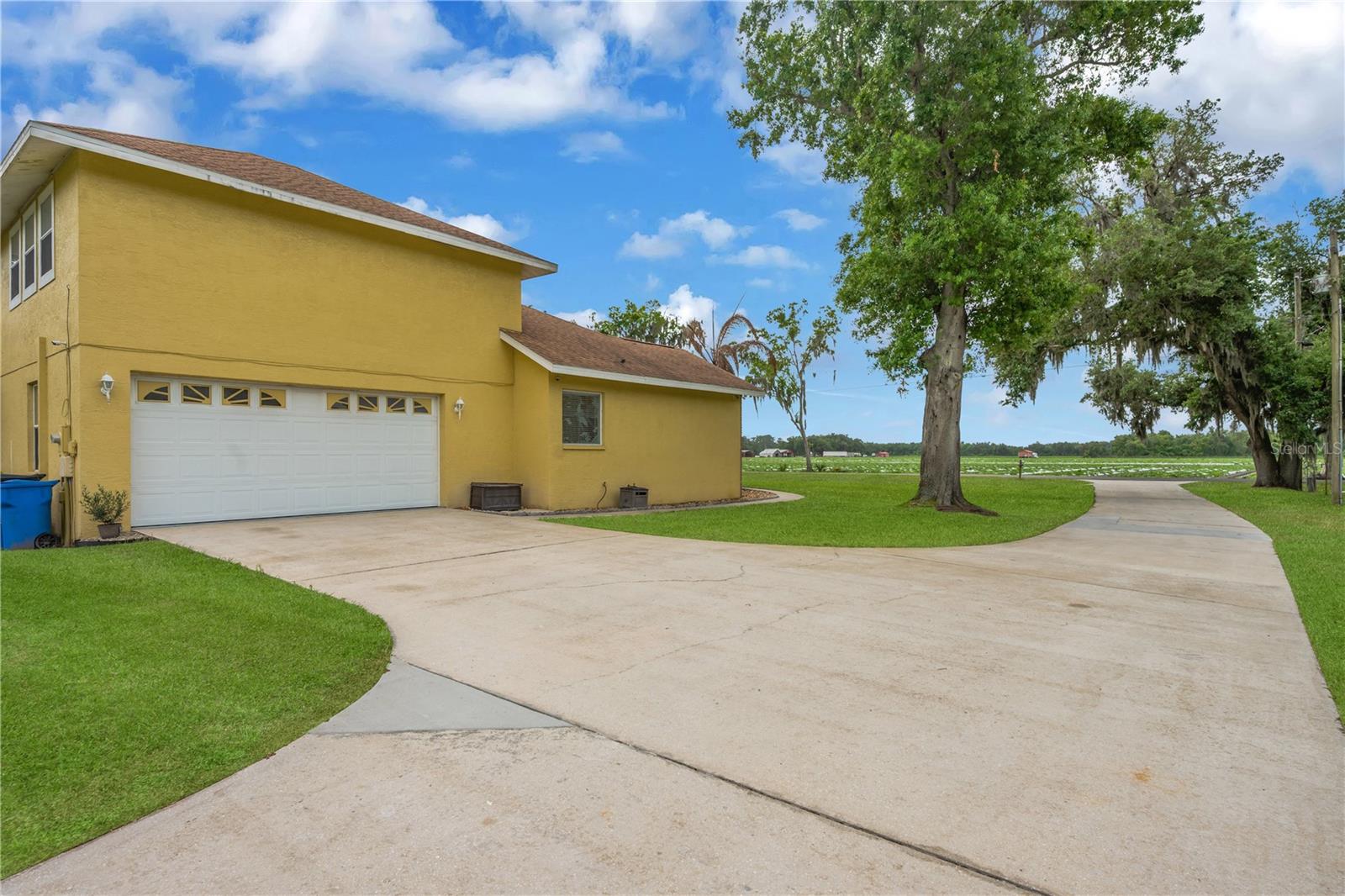 Attached side-entry 2-car garage with space enough for a full-size truck and an extended driveway offering ample parking for multiple vehicles, guests, boats, or RVs.
