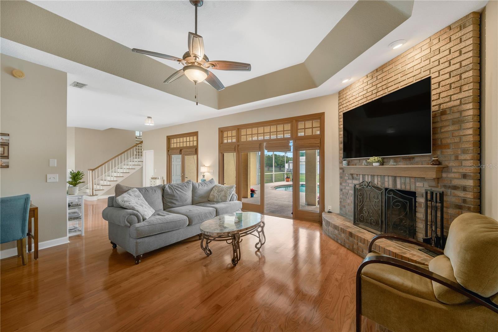 This one-of-a-kind custom-built home invites you to step through beautiful wood French doors onto a spacious covered lanai and screened pool area.