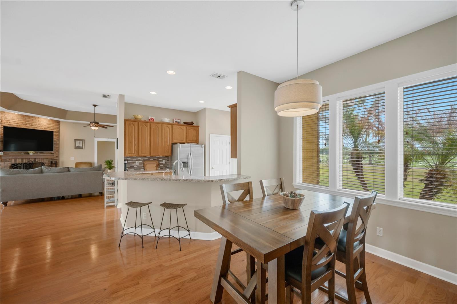 This spacious main-floor great room offers both comfort and flexibility, with two secondary bedrooms and a guest bathroom located in the east wing, while the stunning primary suite enjoys privacy in the west wing of the downstairs layout.