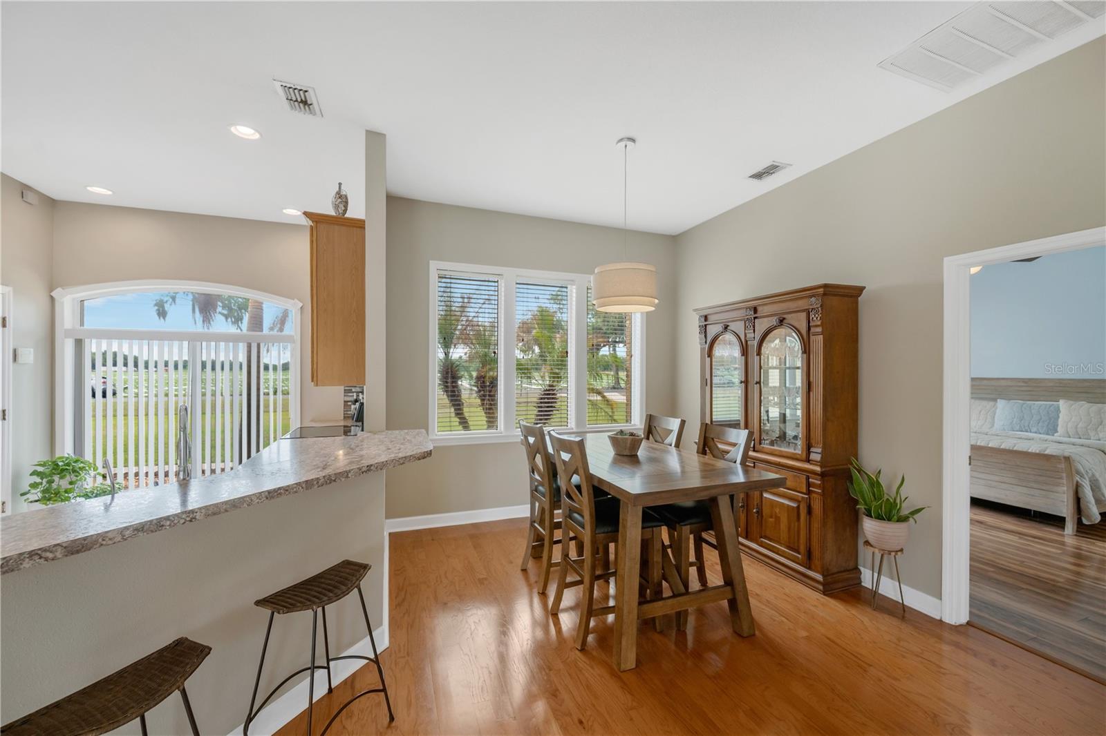 A convenient dining area beside the kitchen, open to the breakfast bar, creates an easy flow for entertaining and offers additional seating options when guests gather.