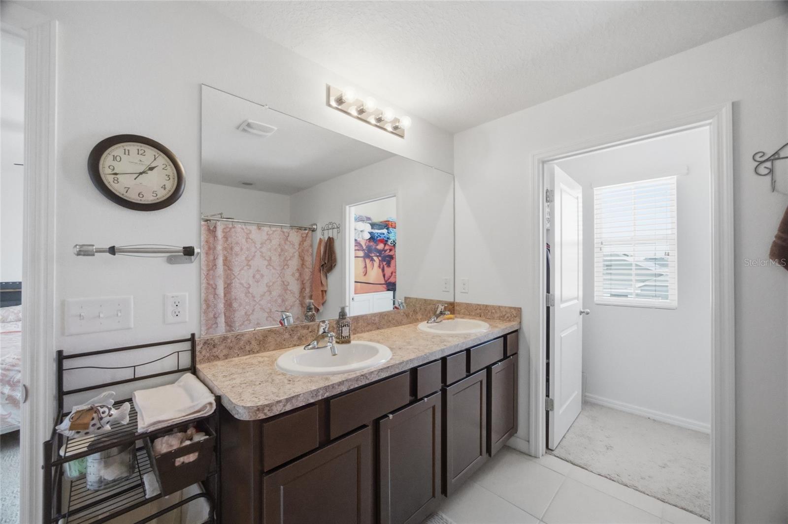 Primary bathroom with dual sinks & 2 walk-in closets
