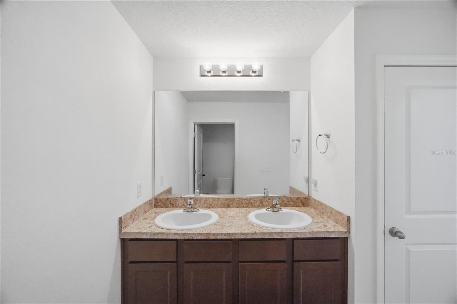 2nd floor full bath with dual sinks, linen closet & private commode and bathing area